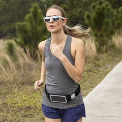 Woman jogging with Lucyd Lyte Bluetooth Sunglasses and phone belt for audio control