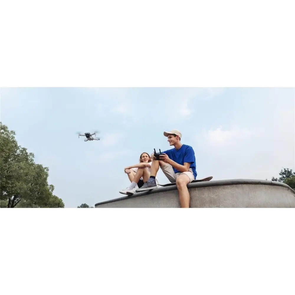 DJI Mavic Mini Combo Ultra Light Drone soaring through the sky in flight