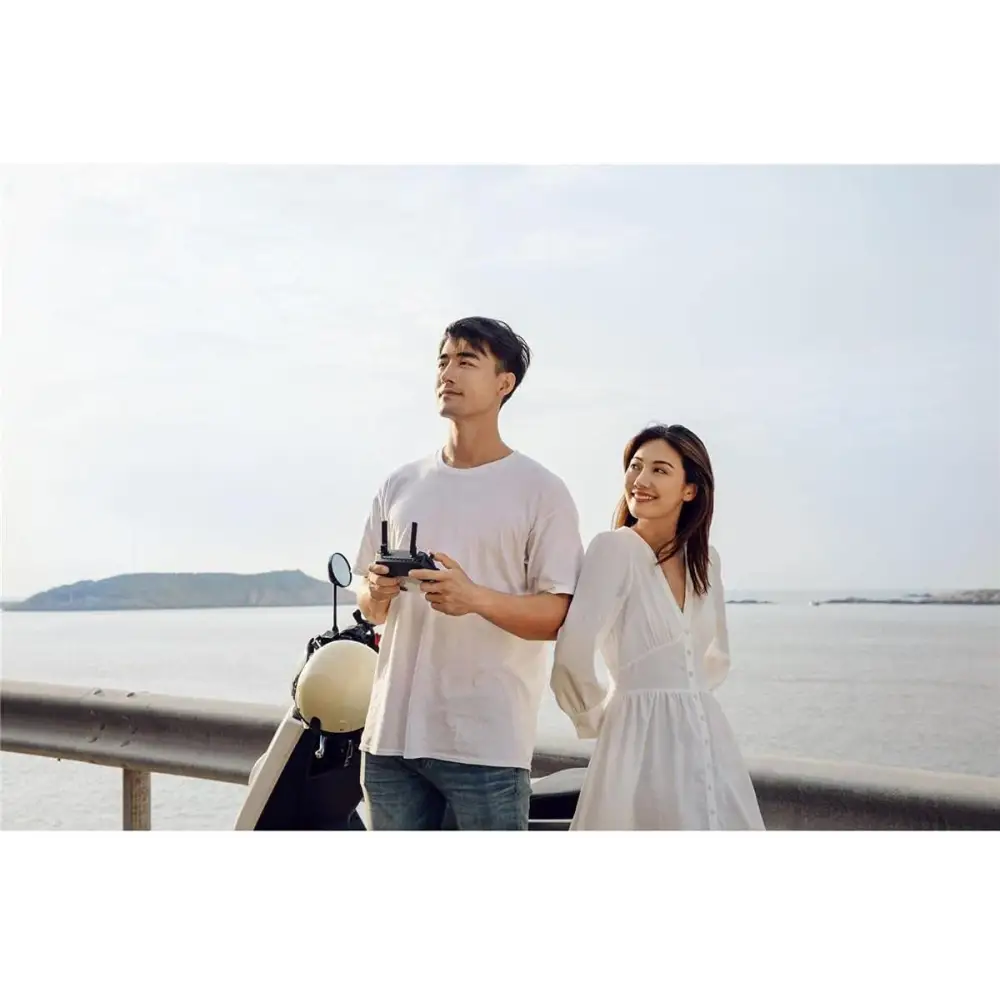 Couple using DJI Mavic Mini Combo Ultra Light Drone controller outdoors