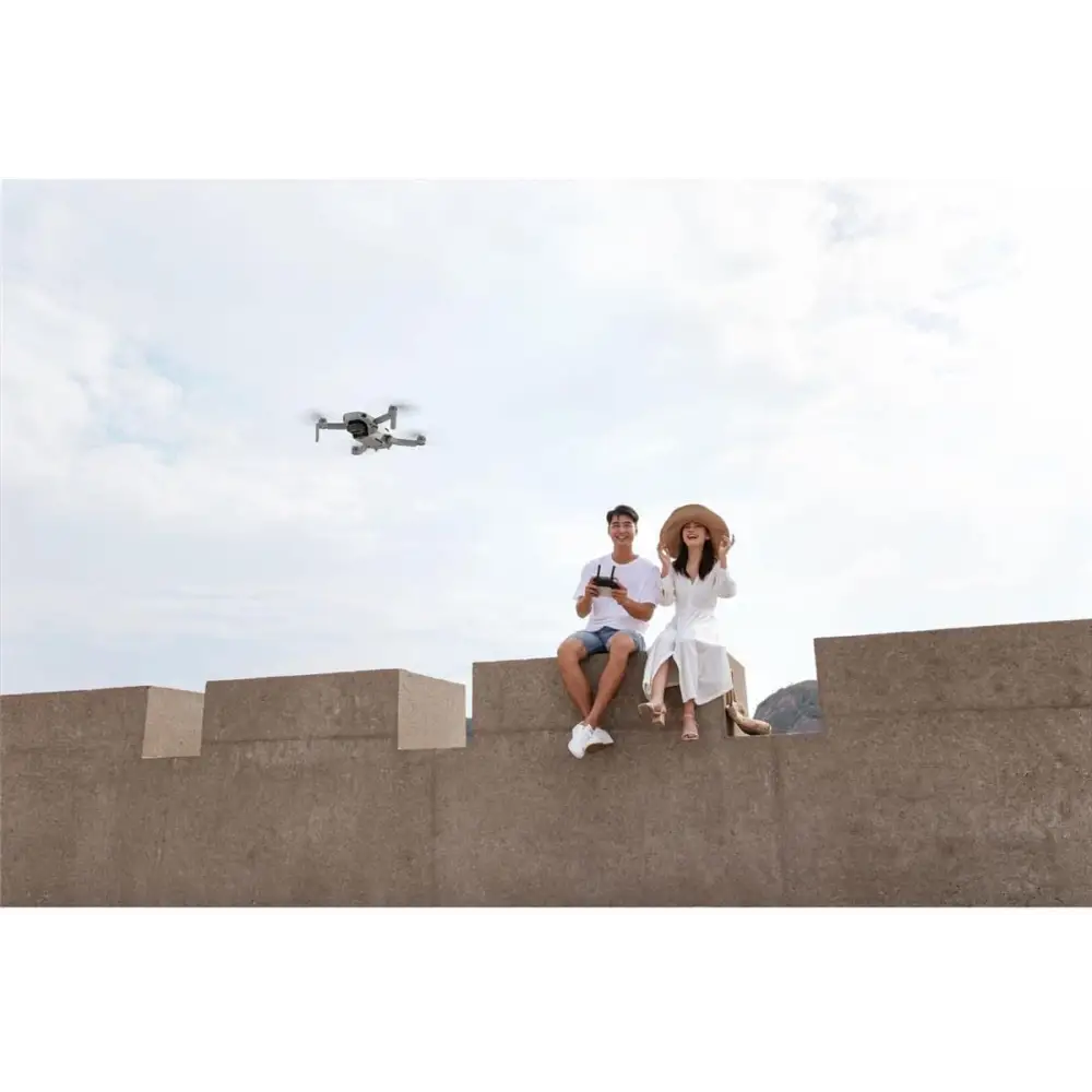DJI Mavic Mini Combo Ultra Light Drone flying in clear blue sky
