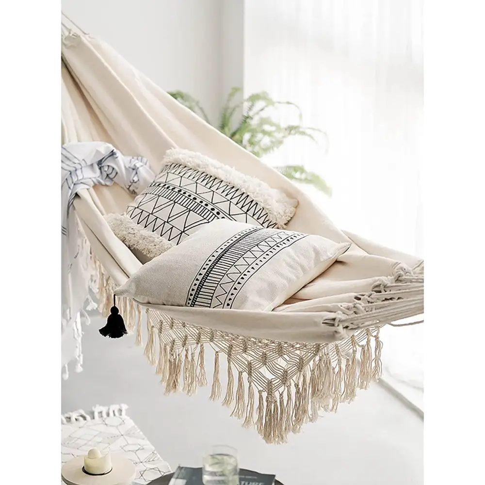Bohemian hammock with pillows and macrame fringe for outdoor relaxation comfort
