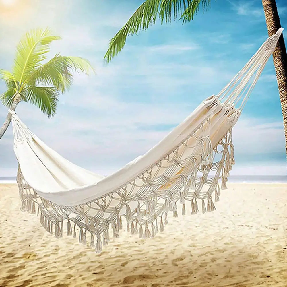White fringed hammock from Boho Macrame Hammock for outdoor relaxation