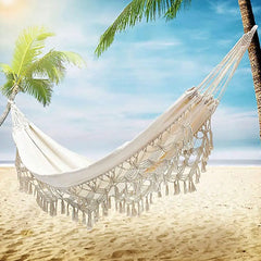White fringed hammock from Boho Macrame Hammock for outdoor relaxation