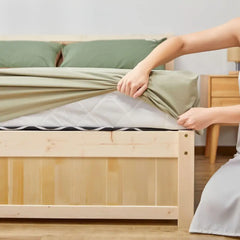 Bed with green grounding sheet featuring silver fibers for inflammation reduction