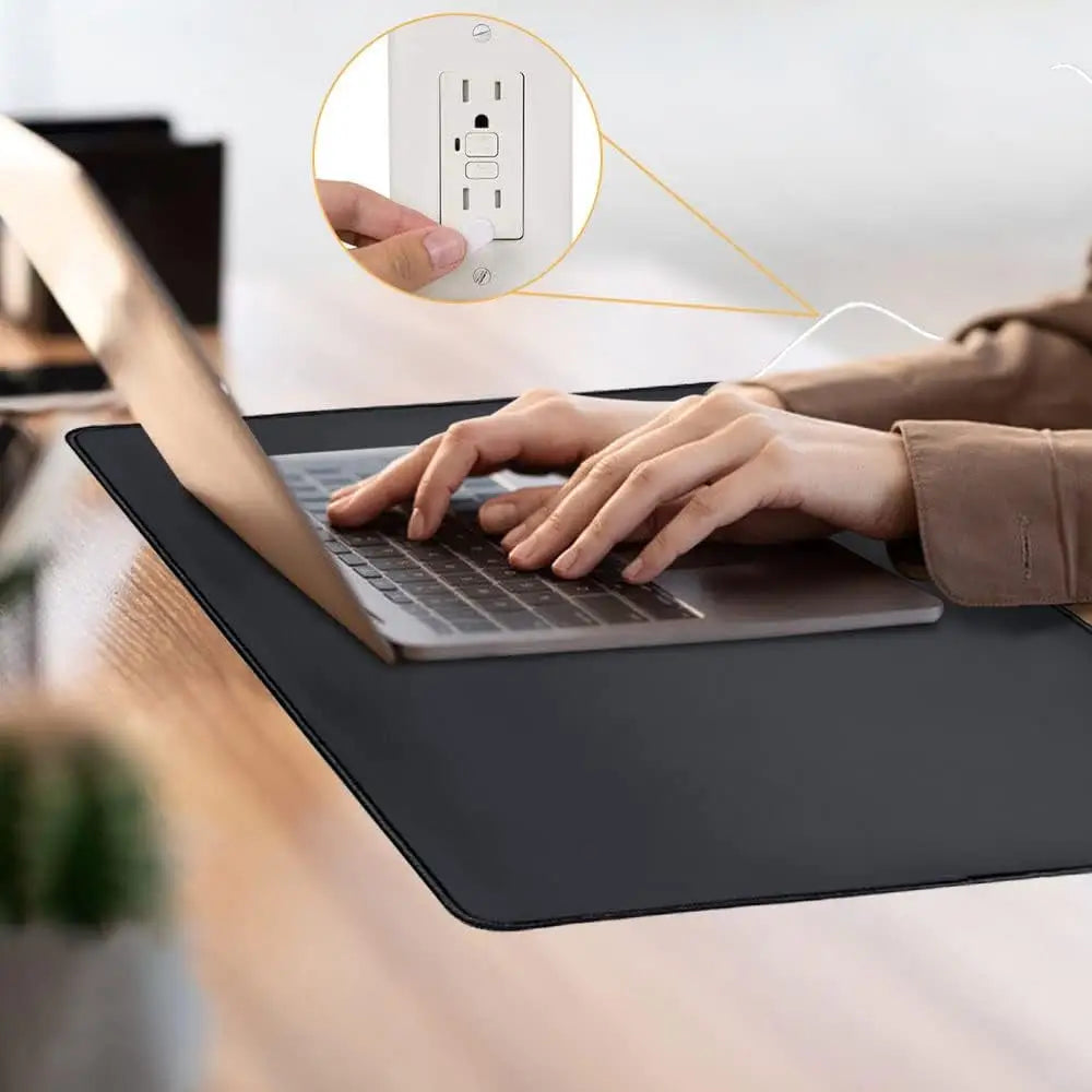 Laptop on a black desk mat showcasing the Black Grounding Mat for Anxiety Reduction and Sleep