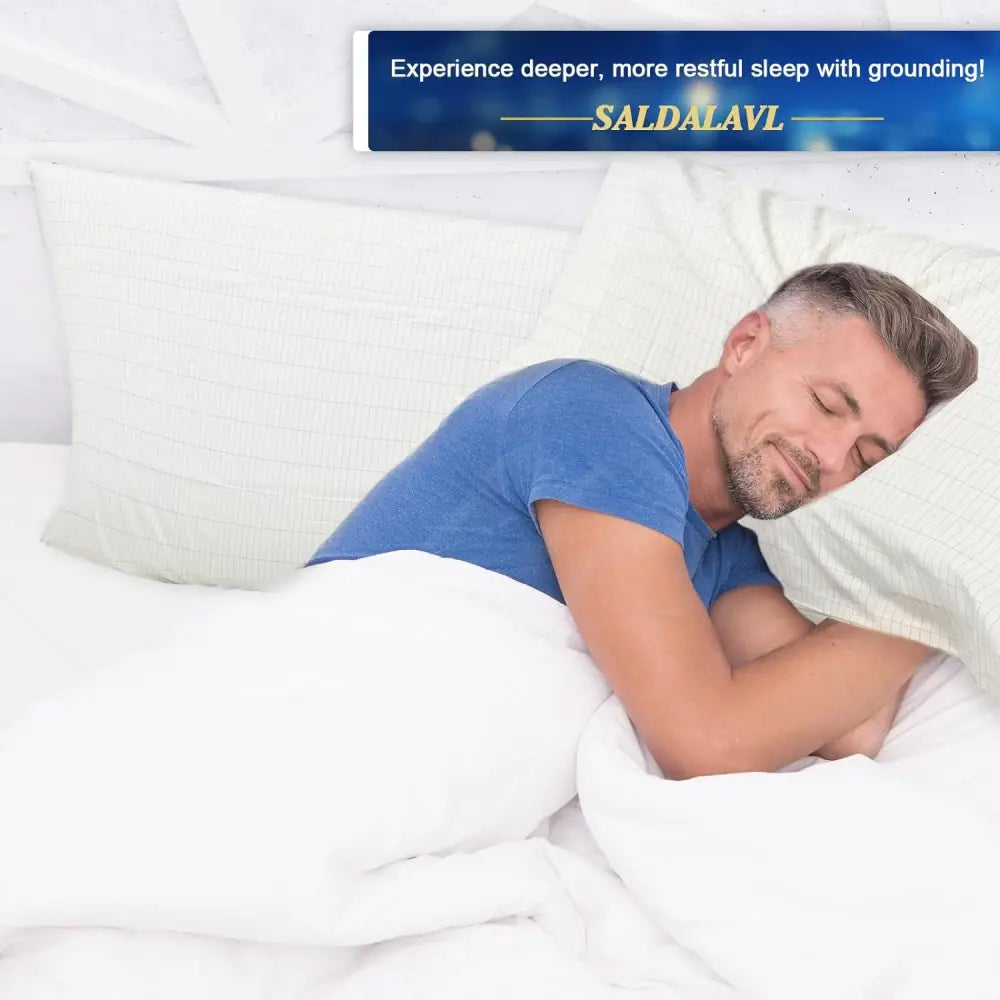 Man peacefully sleeping in bed with Queen Grounding Pillowcases Silver Fiber Set