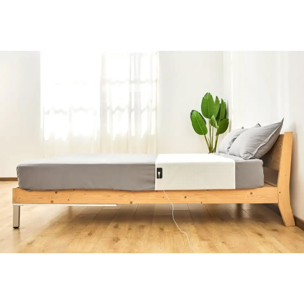 Wooden bed frame with gray bedding from GroundingWell Bed Sheet Set for sleep relief