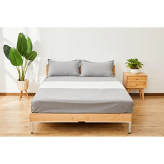Gray bed with matching pillows from GroundingWell Bed Sheet Set for sleep and inflammation relief