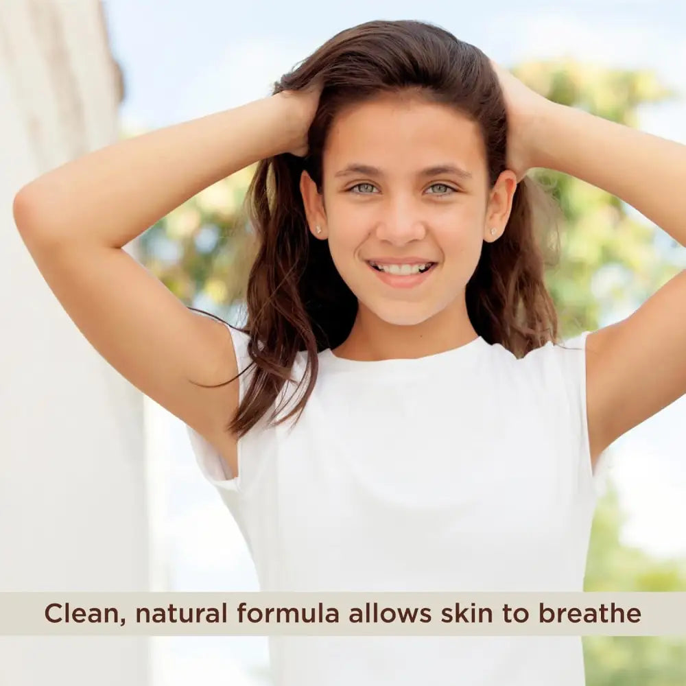 Smiling young girl with hands in hair promoting Natural Aluminum Free Deodorant for Teens