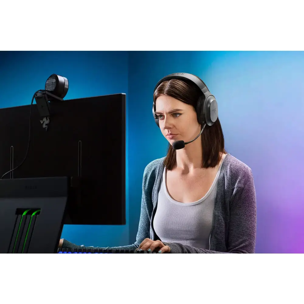 Woman using Razer Barracuda X Wireless USB-C Headset with detachable mic