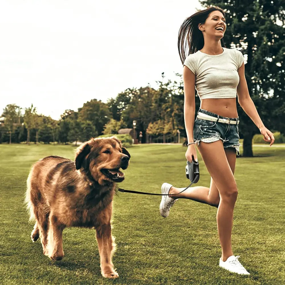 Woman jogging with dog using Red Reflective Retractable Dog Leash Anti-Slip Handle