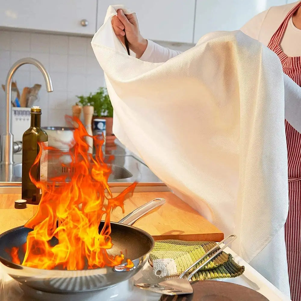 Kitchen fire being smothered with TONYKO Advanced Fiberglass Fire Blanket Heat Shield