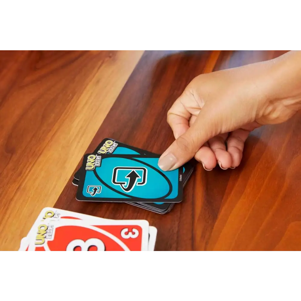 Uno cards spread on a table showcasing the Uno Flip Action Packed Double Sided Deck